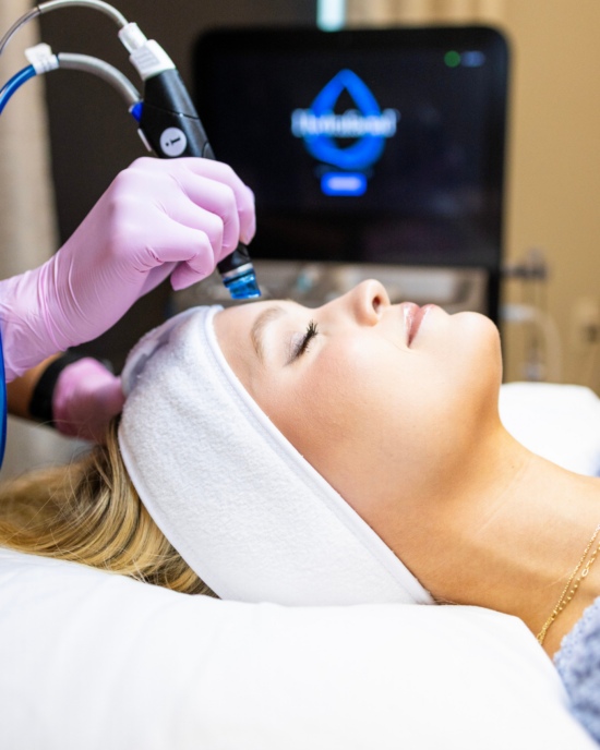 A woman receiving a professional bridal aesthetic treatment before her wedding in Oklahoma City