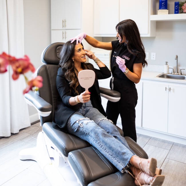 A licensed professional assesses a woman's skin health during a med spa visit in Oklahoma City