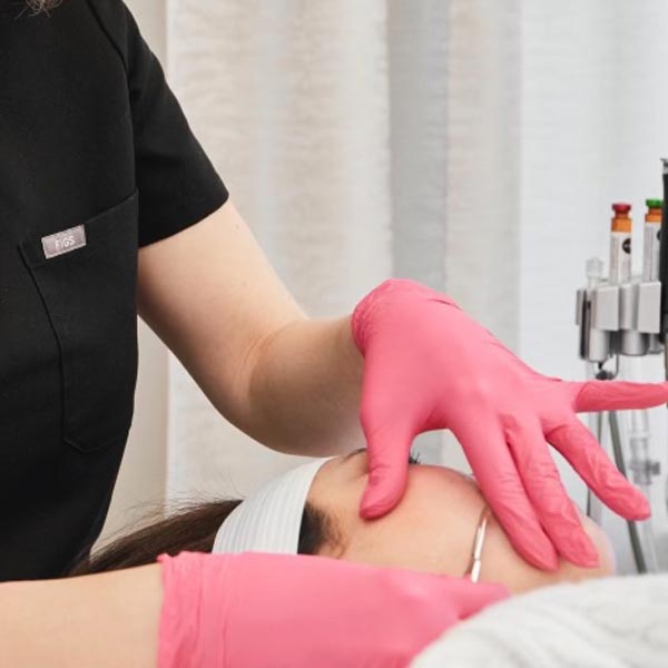 woman receiving dermaplaning treatment